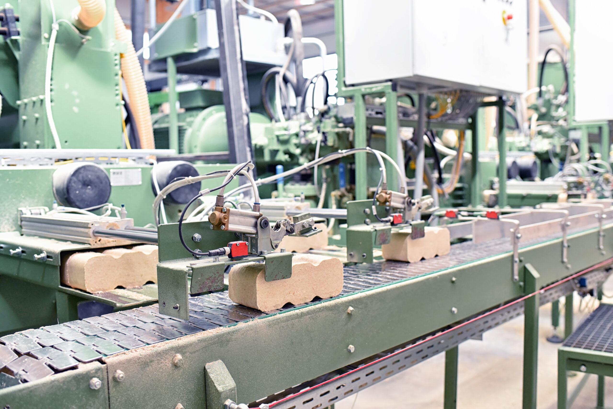 Industrial production line with workers who may be at risk of injury