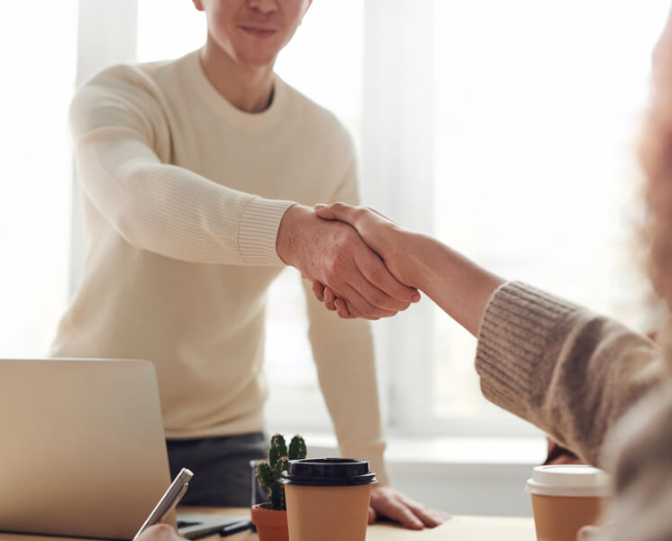 A handshake symbolizing a No Win No Fee agreement between solicitor and client