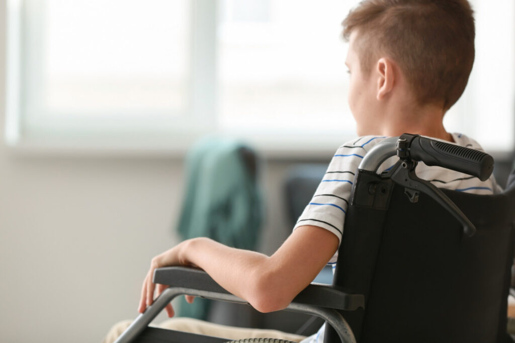 Wolf Law are the number one accident solicitors in Liverpool and the Wirral, supporting claims for personal injury claims in Liverpool Wolf Law are the number one accident solicitors in Liverpool and the Wirral, supporting claims for personal injury claims in Liverpool Back view of a person in a wheelchair facing a sunlit window in a bright room, wearing a striped shirt and short hair.