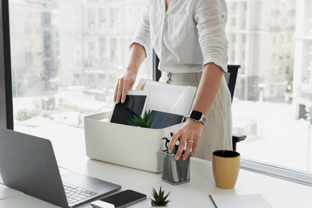 How to claim compensation for unfair dismissal - Wolf Law Wolf Law 2149480600 Person in a white shirt places folders and a tablet into a white desk organizer on a bright office desk.