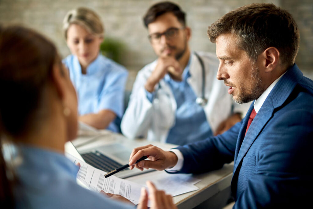Wolf Law - The Top Accident Solicitors In Liverpool Wolf Law Wolf Law - The Top Accident Solicitors In Liverpool Wolf Law 7068 Wolf Law are the number one accident solicitors in Liverpool and the Wirral, supporting claims for personal injury claims in Liverpool Wolf Law are the number one accident solicitors in Liverpool and the Wirral, supporting claims for personal injury claims in Liverpool Medical professionals in a meeting reviewing documents at a table, with a doctor in a blue suit leading the discussion.