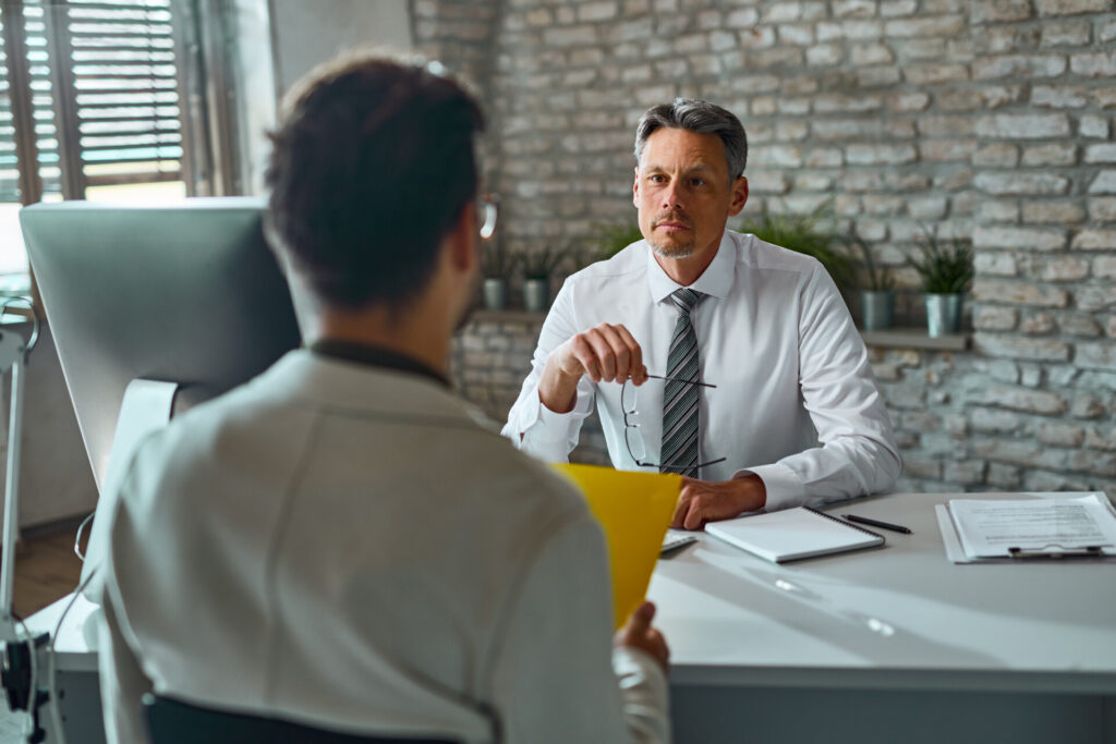 Wolf Law - The Top Accident Solicitors In Liverpool Wolf Law Wolf Law - The Top Accident Solicitors In Liverpool Wolf Law Businessman talking to a candidate during job interview in the o Wolf Law are the number one accident solicitors in Liverpool and the Wirral, supporting claims for personal injury claims in Liverpool Wolf Law are the number one accident solicitors in Liverpool and the Wirral, supporting claims for personal injury claims in Liverpool Two professionals sit at a desk in a modern office; one facing the camera holds glasses while the other, with back to us, discusses documents.