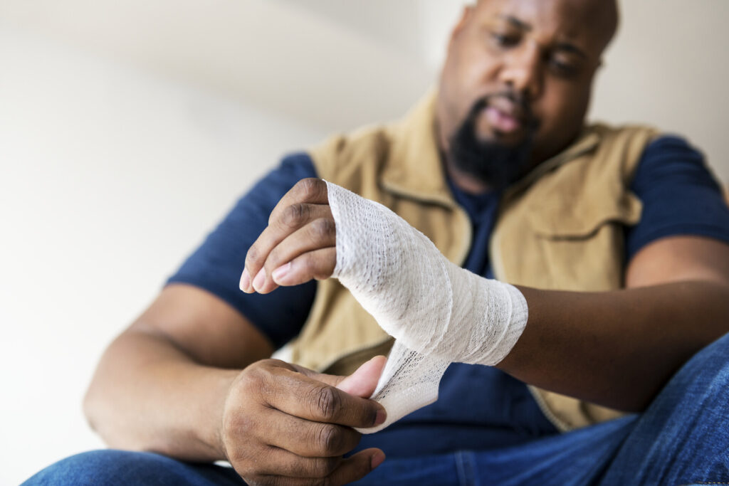 Wolf Law are the number one accident solicitors in Liverpool and the Wirral, supporting claims for personal injury claims in Liverpool Wolf Law are the number one accident solicitors in Liverpool and the Wirral, supporting claims for personal injury claims in Liverpool Man wrapping a white bandage around his injured hand (close-up).